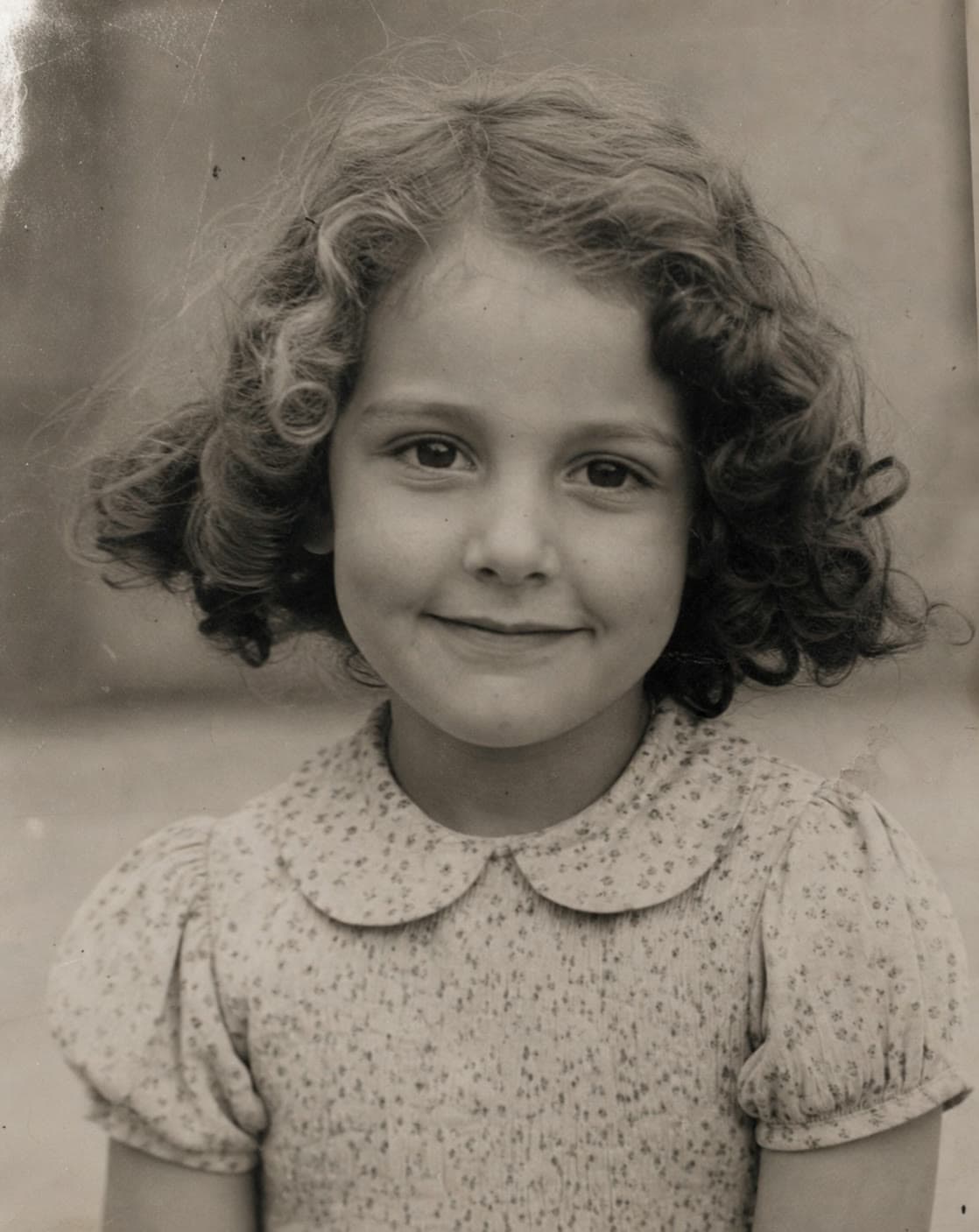 Faded childhood portrait before AI restoration